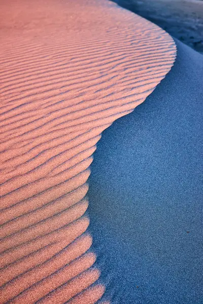 stock image Golden hour light dances on textured sand dunes at Gold Beach, Meyers Creek Beach, Oregon. The warm and cool tones create a mesmerizing contrast, exemplifying the serene beauty of the west coast.