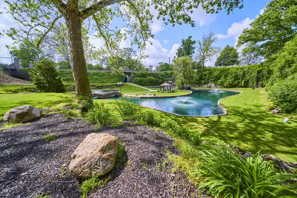 stock image Serene backyard garden in Huntingtons Sunken Gardens, featuring a large pool, lush lawn, and quaint gazebo. Perfect for relaxation and outdoor gatherings under clear blue skies. Ideal for real estate