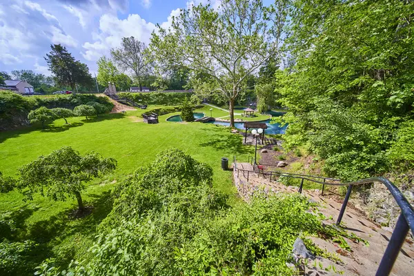 stock image Sunken Gardens in Huntington, Indiana: A lush oasis featuring a descending stone staircase, tranquil pond with a quaint gazebo, and manicured lawns bordered by vibrant greenery. Perfect for relaxation