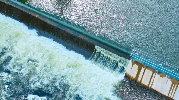stock image Aerial view of Bend Spillway Dam in Oregon, showcasing serene upstream water, cascading waterfall, and frothy downstream turbulence. A testament to engineering prowess and natures power. Ideal for
