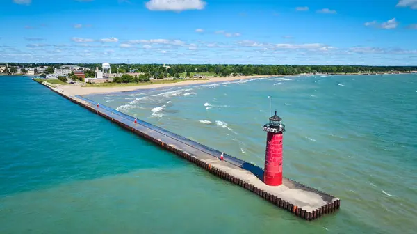 stock image Aerial view of Kenosha Lighthouse on Lake Michigan. The bright red lighthouse stands tall on the pier, guiding vessels. The serene shoreline and small-town charm make for a picturesque coastal scene