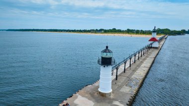 Serene aerial view of Benton Harbor North Pier with two iconic lighthouses standing tall at the edge of Lake Michigan. The white lighthouse leads to the red-roofed one, symbolizing guidance and clipart