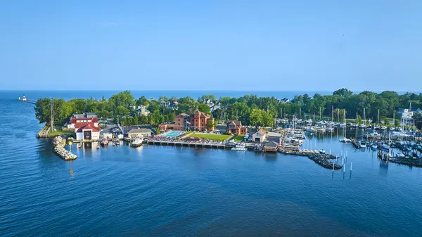 stock image Aerial view of Benton Harbors stunning waterfront on Lake Michigan. Featuring a historic red-brick building, a vibrant marina, and a picturesque lighthouse, this serene scene captures the essence of