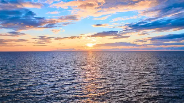 stock image Aerial view of a stunning sunset over Lake Michigan at golden hour, capturing the serene beauty of Benton Harbor and St. Joseph. The tranquil scene showcases the warm glow reflecting off the rippling