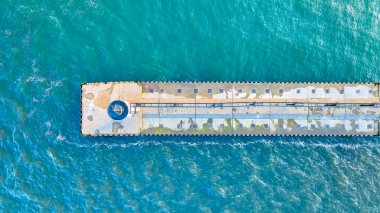 Aerial view of Benton Harbors weathered North Pier extending into Lake Michigan with an Outer Lighthouse at the end. The vibrant blue-green water and serene lighting capture coastal engineerings clipart