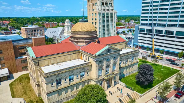 stock image Aerial view of South Bends historic St. Joseph Circuit Courthouse with its red-tiled roof and central dome, surrounded by a blend of modern and historic buildings, highlighting urban development and