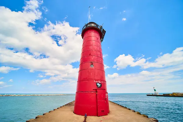 stock image Stunning red Kenosha Lighthouse stands tall on a tranquil pier extending into Lake Michigan. Clear skies and calm waters create a peaceful scene, perfect for travel and maritime photography. Kenosha