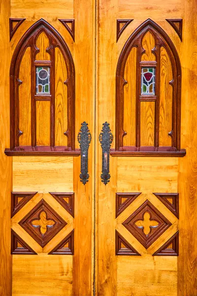 stock image Intricate wooden doors of the Basilica of the Sacred Heart on Notre Dame campus, South Bend, Indiana. Featuring Gothic arches, stained glass, and ornate metal handles, showcasing heritage and