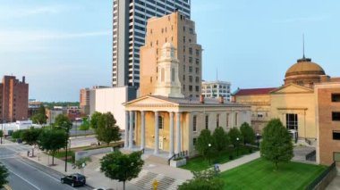 Günbatımında tarihi St. Joseph Küçük Talepler Mahkemesi 'ne odaklanarak South Bend Indiana şehir merkezindeki yaya manzarası çekildi. Adliye binası saat kulesi ve sütunlar altın ışıkla parıldıyor.