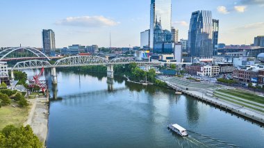 Nashville 'in havadan görünüşü, sakin nehir kıyısını beyaz kemerli bir köprü, bir tekne, canlı bir şehir sanatı ve hareketli bir şehir silüeti ile gösteriyor. Şehir planlama ve turizm için mükemmel..