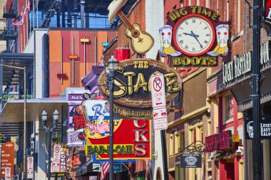 Nashville 'deki hareketli Broadway: The Stage honky-tonk, Big Time Boots saati ve Rippys Bar-B-Que için renkli tabelalar bu ikonik caddenin enerji ve müzik cazibesini ön plana çıkarıyor.