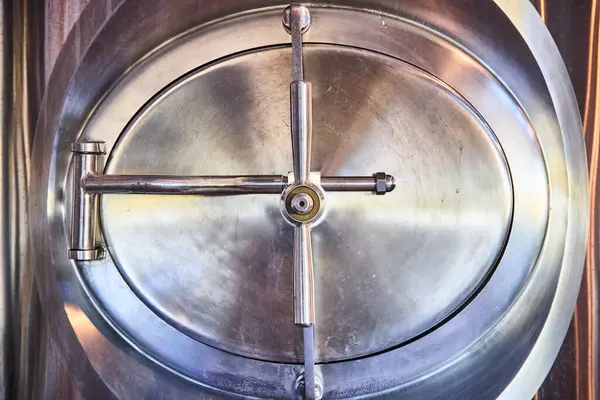 stock image Industrial strength meets precision engineering: A polished metal hatch at a Hoagland, Indiana facility showcases advanced orchard equipment for secure and high-pressure storage solutions.