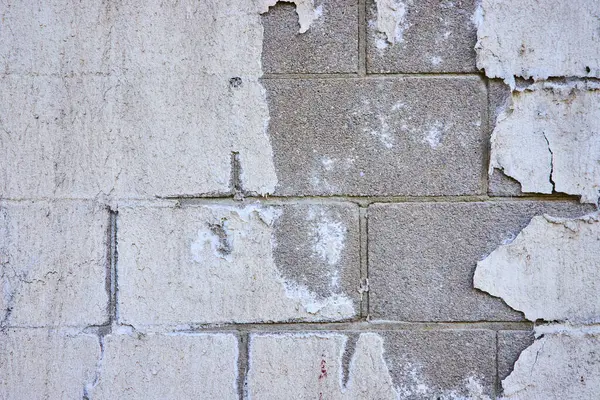 stock image Weathered wall in Toledo, Ohio reveals peeling paint and exposed bricks. The gritty texture captures urban decay, offering a rich backdrop for themes of neglect resilience and historical charm.