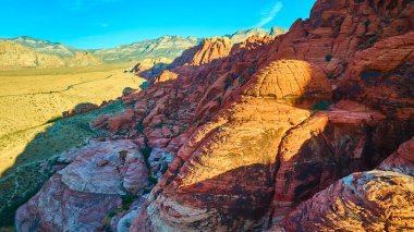 Breathtaking aerial view of Nevada Red Rock Canyon with its vibrant sandstone formations. Experience natures beauty under a golden sky, perfect for adventurers and nature enthusiasts. clipart