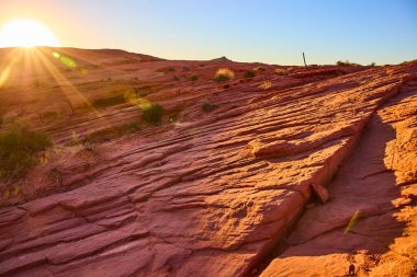 Bask in the golden hour at Valley of Fire, Nevada. Red rock formations stretch across the horizon, casting long shadows and highlighting the deserts untouched beauty and timeless tranquility. clipart