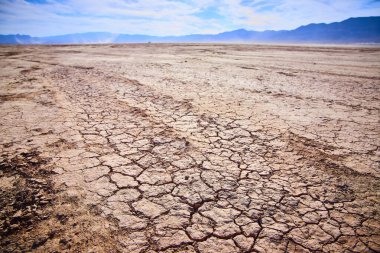 Breathtaking view of Boulder City Dry Lake Bed in Las Vegas Nevada. Cracked earth stretches under a vast blue sky highlighting the stark beauty and challenges of arid desert landscapes. clipart