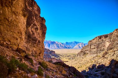 Discover the rugged beauty of Cowboy Canyon in Las Vegas Nevada. Clear blue skies and striking rock formations invite adventure in this stunning desert landscape perfect for nature enthusiasts. clipart