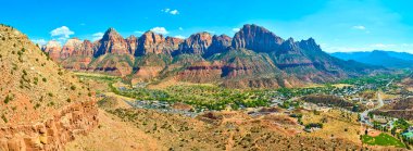 Majestic view of Zion National Park iconic red rock formations with Springdale nestled below. Experience the harmony of desert landscapes and vibrant town life under a clear Utah sky. Perfect for clipart