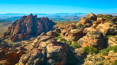 Aerial view of Snow Canyon State Park in Utah showcases dramatic red rock formations against a clear sky. The vast desert landscape highlights the timeless beauty of the American Southwest. clipart