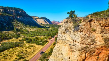 Discover the breathtaking beauty of Zion National Park with this aerial view of a winding road through a dramatic desert canyon. Experience adventure and freedom on the open road in Utah stunning clipart