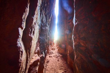 Sunlit passage through the red rock canyons of Snow Canyon State Park, Utah invites adventurers to explore its dramatic desert beauty and towering formations. Ideal for travel and nature enthusiasts. clipart