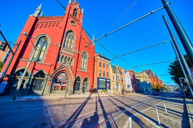 Capture the grandeur of Cincinnati Music Hall with its Gothic architecture and vibrant urban charm. Stroll along cobblestone streets, where history meets modern life under a bright blue sky. clipart