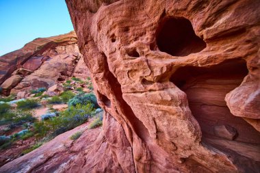 Bask in the majestic beauty of Snow Canyon State Park in Utah. The striking red rock formations against a clear blue sky create a serene desert scene, perfect for adventure and exploration enthusiasts clipart