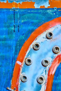 Weathered bolts on a vibrant blue and orange surface in Nelson, Nevada. This rustic abstract captures the resilience and history of vintage machinery in a ghost town setting. clipart