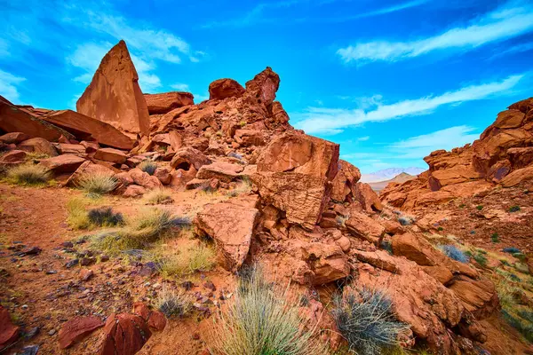 Nevada, Boulder City 'de engebeli kırmızı kaya oluşumları parlak mavi bir gökyüzünün altında dimdik ayakta duruyor. Bu çarpıcı çöl manzarası, Redstone Kumulları 'nın eşsiz jeolojisinin ebedi güzelliğini yansıtıyor. Tam oldu.