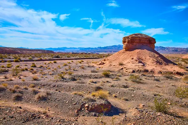Uzak dağlar ve parlak mavi gökyüzü tarafından çerçevelenmiş kurak Nevada çölünden görkemli kaya oluşumları yükselir. Northshore Yolu 'ndaki bu eşsiz manzaranın ebedi güzelliğini ve yalnızlığını tecrübe edin..
