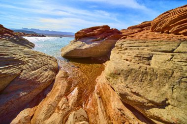 Canlı kumtaşı oluşumları ve köpüklü su Sand Hollow State Park Utah 'ta sersemletici bir çöl manzarası yaratıyor.