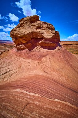 Arizona 'daki Arı Kovanı Patikası boyunca yükselen güneş taşı girdapları parlak mavi gökyüzüne karşı canlı kırmızı ve turuncu katmanlar sergiliyor.