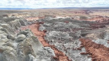 Kanab Utah yakınlarındaki Grand Escalante bölgesindeki beyaz kumtaşı uçurumları ve kırmızı kayalıkların üzerinden uçan hava aracı, dramatik çöl arazisi ve Toadstool Hoodoo Patikası boyunca geniş manzaralı....