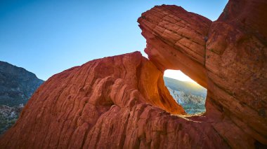 Altın Butte Ulusal Anıtı 'nın altın saatinde, Nevada' da Whitney Pocket ve çöl arazisi ile birlikte güneş ışığı kırmızı bir kaya kemer düzeninde parlıyor.