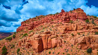 Kanab Utah 'ın canlı kırmızı bir kayayı gösteren hava manzarası... yemyeşil bir çöl bitkisi ve dramatik kümülüs bulutları... Amerika' nın güneybatısının engebeli güzelliğini ve macerasını yakalıyor.