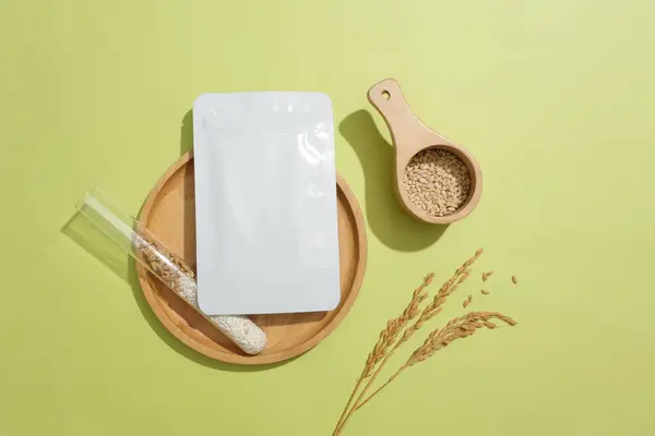 Whole grain rice is stored in a test tube and a mask sheet on a round wooden tray. Rice bran contains Squalene, an ingredient that helps keep skin moisturized and maintains skin elasticity.
