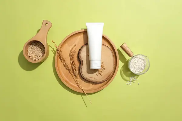 A cosmetic tube with rice bran extract stands out on a pastel background. Skin care with natural ingredients found in cosmetics. Copy space for ads.