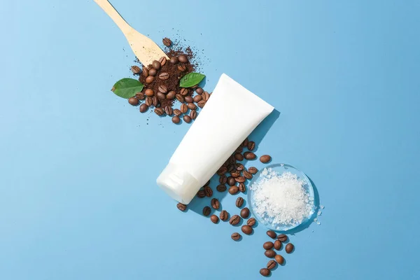 Close Cosmetic Tube Displayed Sea Salt Coffee Beans Blue Background — Stock Photo, Image