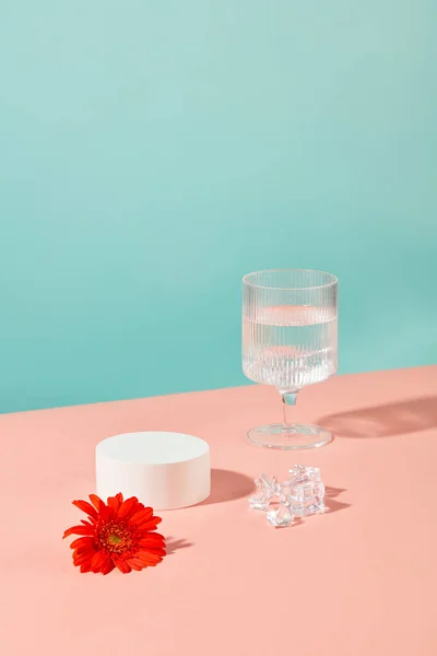 Wine Glass Containing Water Red Gerbera Flower Ice White Podium — Stock Photo, Image