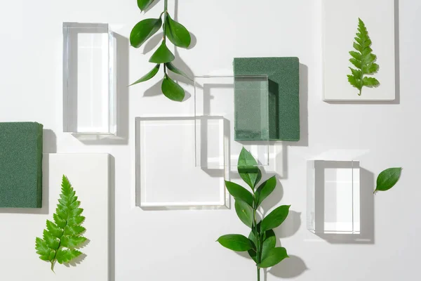 Glazen Podia Versierd Met Groene Bladeren Een Ongerepte Witte Achtergrond — Stockfoto