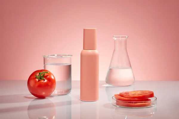Pink Bottle Unbranded Display Pink Background Lab Glassware Tomato Slices — Stock Photo, Image