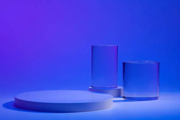 2つの透明なシリンダーオブジェクトで青い背景に装飾された丸い白い表彰台の製品プレゼンテーションのためのブランクの背景 コピーのための空のスペース — ストック写真