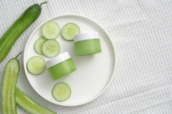Green Cream Jars Unlabeled Cucumber Slices Decorated White Fabric Background — Stock Photo, Image