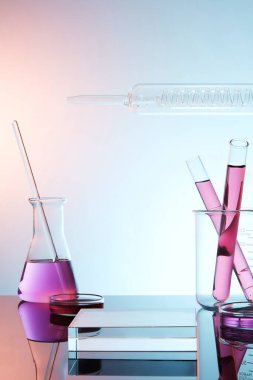 Laboratuar temalı laboratuar cam kaplamalı renkli sıvı ve eğimli arka planda şeffaf boş podyum. Bilim laboratuarı araştırma ve geliştirme kavramı