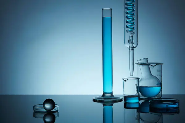 Front View Lab Glassware Containing Blue Solution Right Back Lit — Stock Photo, Image