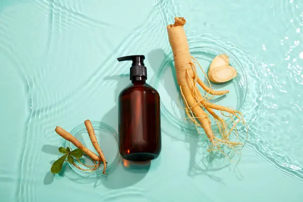 Top view of empty cosmetic bottles and fresh ginseng placed on water background. Mockup for advertising ginseng root extract cosmetics. Flat lay.