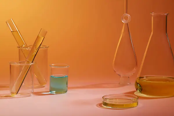 Orange Background Many Laboratory Glassware Filled Yellow Blue Fluid Concept — Stock Photo, Image