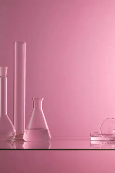 Several Laboratory Glassware Containing Transparent Liquid Placed Glass Table Purple — Stock Photo, Image
