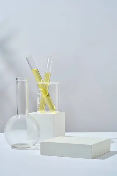 Test Tube Containing Yellow Liquid Beaker Placed Cube Podium Empty — Stock Photo, Image
