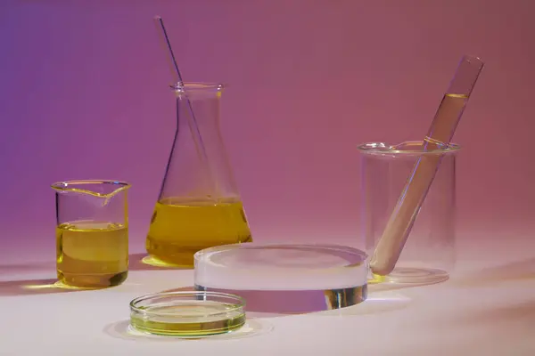 Purple Background Laboratory Glassware Containing Yellow Fluid Decorated Podium Research — Stock Photo, Image